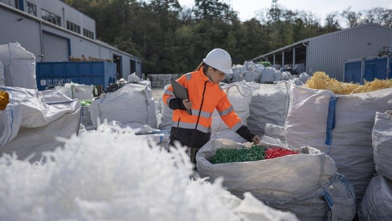 Plastic pellets and recycled resin material in an industrial processing setting